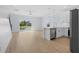 Bright open-concept kitchen and living area featuring hardwood floors, white cabinets, and balcony access at 2302 Seaseeker Ln., Myrtle Beach, SC 29577