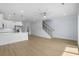 Open living room and modern kitchen with staircase and wood flooring at 2302 Seaseeker Ln., Myrtle Beach, SC 29577