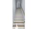 Bright staircase featuring white risers, light wood treads, and a natural wood handrail for a modern look at 2302 Seaseeker Ln., Myrtle Beach, SC 29577