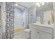 Clean bathroom with white vanity, shower/tub combo, and patterned shower curtain at 301 Climbing Vine Ct., Conway, SC 29526