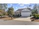 Gray house with white garage door and landscaping at 301 Climbing Vine Ct., Conway, SC 29526