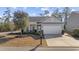Gray house with white garage door, landscaping, and mailbox at 301 Climbing Vine Ct., Conway, SC 29526