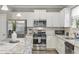 Modern kitchen with stainless steel appliances and granite countertops at 301 Climbing Vine Ct., Conway, SC 29526