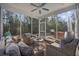 Screened porch with wicker furniture and view of backyard with grill and patio furniture at 301 Climbing Vine Ct., Conway, SC 29526