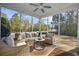 Relaxing screened porch with wicker furniture, creating an outdoor living space at 301 Climbing Vine Ct., Conway, SC 29526