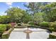 Manicured backyard featuring a brick-lined patio and lush landscaping at 356 Rossdhu Ave., Pawleys Island, SC 29585