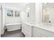 Elegant bathroom with dual sinks, bathtub, walk-in shower, and a neutral color scheme at 356 Rossdhu Ave., Pawleys Island, SC 29585