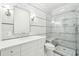 Stylish bathroom with a glass shower, marble wall tiles, black accent stripe, and a dual vanity at 356 Rossdhu Ave., Pawleys Island, SC 29585