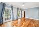 Spacious bedroom with wood floors, light blue walls, and large windows with nice drapes at 356 Rossdhu Ave., Pawleys Island, SC 29585