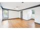 Spacious bedroom with hardwood floors, ceiling fan, and large window at 356 Rossdhu Ave., Pawleys Island, SC 29585