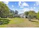 Expansive backyard with lush lawn and mature trees surrounding the house at 356 Rossdhu Ave., Pawleys Island, SC 29585