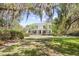 A beautiful two-story home with a manicured lawn and mature trees at 356 Rossdhu Ave., Pawleys Island, SC 29585