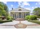 Stately home exterior with columned porch and brick-lined steps and circular driveway at 356 Rossdhu Ave., Pawleys Island, SC 29585