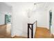 Bright hallway with wood floors, white walls, and chandelier lighting at 356 Rossdhu Ave., Pawleys Island, SC 29585