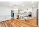 Bright kitchen features white cabinets, stainless steel appliances, an island, and wood floors at 356 Rossdhu Ave., Pawleys Island, SC 29585