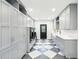 Modern laundry room with gray cabinetry, checkerboard flooring, and stainless steel washer/dryer at 356 Rossdhu Ave., Pawleys Island, SC 29585
