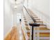 Classic staircase design with wood steps, white risers, and a dark wood handrail at 356 Rossdhu Ave., Pawleys Island, SC 29585