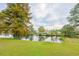 Landscaped backyard with pond and lush green grass at 417 Grain Field Dr., Georgetown, SC 29440