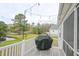 Deck overlooking a pond, featuring string lights and a grill at 417 Grain Field Dr., Georgetown, SC 29440