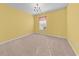 Empty bedroom with neutral carpet, chandelier, and natural light from a window with shades at 4463 Livorn Loop # 4463, Myrtle Beach, SC 29579