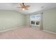 Inviting bedroom with a ceiling fan, neutral carpet, and a window offering serene outdoor views at 4463 Livorn Loop # 4463, Myrtle Beach, SC 29579