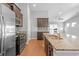 Open concept kitchen showcasing stainless steel appliances, gas range, and an island with a sink and breakfast bar at 4463 Livorn Loop # 4463, Myrtle Beach, SC 29579