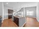Open concept kitchen and dining room with island, stainless steel appliances, and modern fixtures at 4463 Livorn Loop # 4463, Myrtle Beach, SC 29579