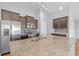 Spacious kitchen island featuring granite countertops, modern appliances, stylish backsplash, and dark wood cabinets at 4463 Livorn Loop # 4463, Myrtle Beach, SC 29579