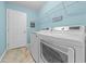 Modern laundry room with sleek, new washer and dryer units, storage shelves, and tiled flooring at 4463 Livorn Loop # 4463, Myrtle Beach, SC 29579