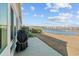 A patio features a grill and faces out onto a pond and a row of single-Gathering homes at 4463 Livorn Loop # 4463, Myrtle Beach, SC 29579