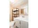 Modern bathroom with a toilet, sink, and storage shelves at 6804 N Ocean Blvd. # 1009, Myrtle Beach, SC 29572