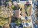 Aerial view of a home with a brown roof, a paved driveway, and green landscaping, situated in a residential neighborhood at 702 Plantation Dr., Surfside Beach, SC 29575