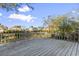Wide wooden back deck overlooking the yard, with railings, ideal for outdoor entertaining and enjoying the surrounding views at 702 Plantation Dr., Surfside Beach, SC 29575