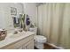 Bathroom featuring a vanity, toilet, and shower-tub combination with curtain at 702 Plantation Dr., Surfside Beach, SC 29575