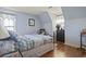 Bedroom with sloped ceiling, two windows with valances, hardwood floors, and black dresser at 702 Plantation Dr., Surfside Beach, SC 29575
