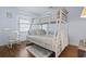 Light and airy bedroom features bunk beds, hardwood floors, and rocking chair at 702 Plantation Dr., Surfside Beach, SC 29575