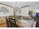 Elegant dining room with chandelier and access to the living room featuring a cozy brick fireplace at 702 Plantation Dr., Surfside Beach, SC 29575