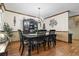 An elegant dining room with a chandelier, a large dining table, and sophisticated decor and wooden floors at 702 Plantation Dr., Surfside Beach, SC 29575