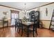 Traditional dining room featuring hardwood floors, a chandelier, and a black china cabinet for ample storage at 702 Plantation Dr., Surfside Beach, SC 29575