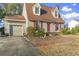 Inviting home with red shutters and front door, a well-maintained lawn, and an attached garage, offering curb appeal at 702 Plantation Dr., Surfside Beach, SC 29575