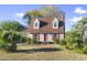Charming home with red shutters and front door, a well-maintained lawn, enhancing its curb appeal at 702 Plantation Dr., Surfside Beach, SC 29575