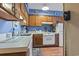 Functional kitchen featuring white appliances, wood cabinets, and ample counter space for easy meal preparation at 702 Plantation Dr., Surfside Beach, SC 29575