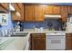 Functional kitchen featuring white appliances, wood cabinets, and ample counter space for easy meal preparation at 702 Plantation Dr., Surfside Beach, SC 29575