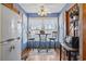 Cozy kitchen nook with bright blue walls, wooden floor, and table with chairs by the window at 702 Plantation Dr., Surfside Beach, SC 29575