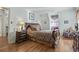Relaxing main bedroom with hardwood floors, sitting area, and natural light at 702 Plantation Dr., Surfside Beach, SC 29575