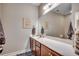 Bathroom features a spacious vanity, a large mirror, neutral walls, and updated fixtures at 8605 Hopper Ct., Myrtle Beach, SC 29579