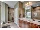 Bathroom with a large mirror, dual sinks, and dark wood cabinets at 8605 Hopper Ct., Myrtle Beach, SC 29579