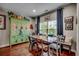 Charming dining room with rustic wooden table, eclectic chairs, and vintage green cabinet at 8605 Hopper Ct., Myrtle Beach, SC 29579