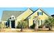 Charming home with a green exterior, well-manicured lawn, and beautiful landscaping at 8605 Hopper Ct., Myrtle Beach, SC 29579