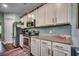 Bright kitchen featuring stainless steel appliances, granite counters, and blue subway tile backsplash at 8605 Hopper Ct., Myrtle Beach, SC 29579